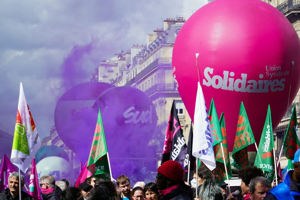 a crowd of people standing around a large balloon